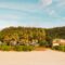 Beautiful beachfront villas with palm trees on a sandy coastline. Ideal tropical getaway.